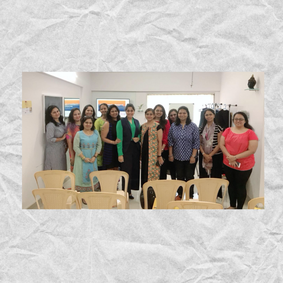 A group of people standing in a room Description automatically generated with medium confidence